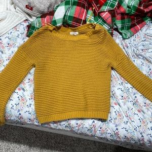 It’s a mustard yellow, knit sweater. very comfy